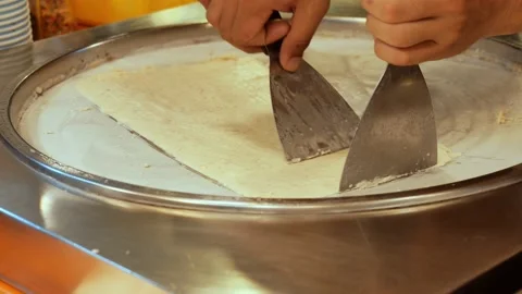 Chef cook Stir-fried ice cream rolls on freeze pan Stock Footage 132850499