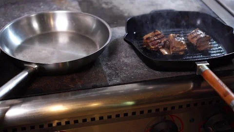 Chef cook taking prepared pork ribs delicious beef meat slices in juicy sauce Stock Footage 105897552