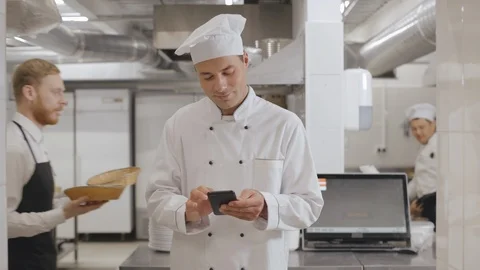 Chef cook using smartphone at the restaurant kitchen Stock Footage 125050881