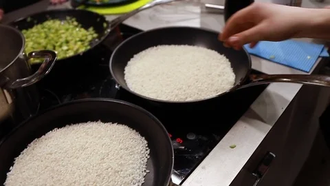 Chef cook warms rice in a pan Stock Footage 113016603
