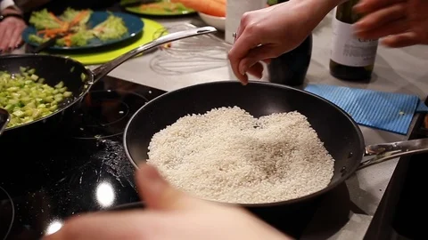 Chef cook warms rice in a pan Stock Footage 115286390