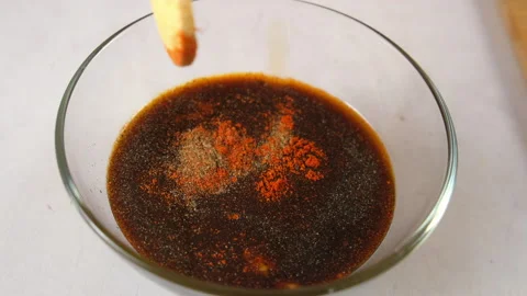 Chef cooking adding spices to soy sauce marinade in glass bowl on kitchen. Stock Footage 317171570