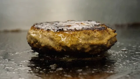 Chef cooking and flips juicy meat for the burger, street food, 4K 60 FPS Stock Footage 76897549