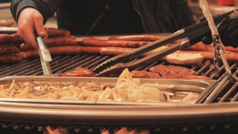 Chef cooking and interfering sausage for hot dogs on the stove Видео 97094119