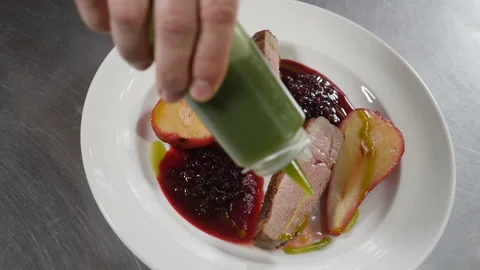 Chef cooking and serving dish. Fine dining. Close-up shot of delicious piece of Stock Footage 127428877