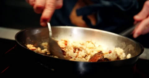 Chef cooking and serving risotto in fine dining restaurant. Stock Footage 178573719