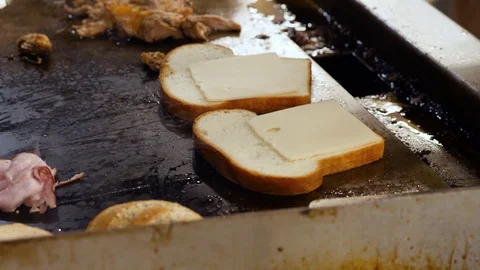 Chef is cooking bacon on big electric frying pan Stock Footage 127600946