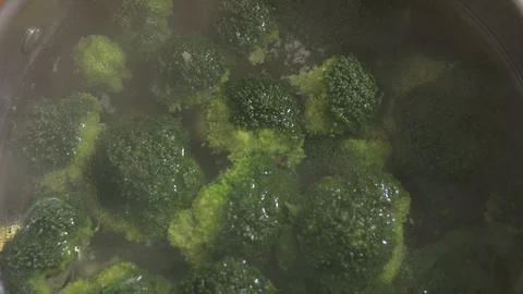 Chef cooking broccoli into saucepan on the kitchen Stock Footage 102704266