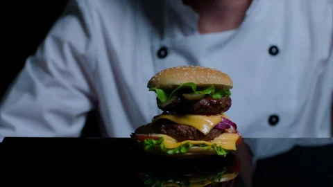 Chef is cooking burger. Black background Stock Footage 92518713