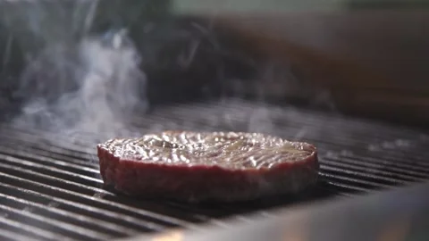 The chef is cooking a burger in the kitchen of the restaurant Stock Footage 132937348