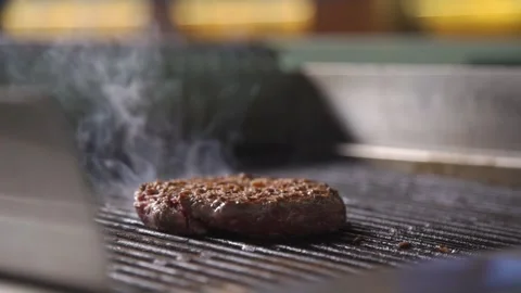 The chef is cooking a burger in the kitchen of the restaurant Stock Footage 132937349