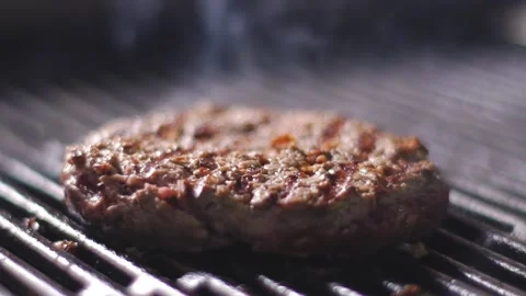 The chef is cooking a burger in the kitchen of the restaurant Stock Footage 132937379