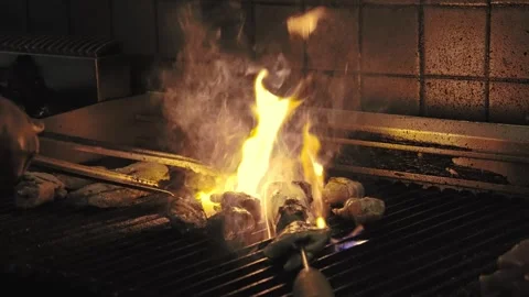 Chef Cooking Chicken Meat in Kitchen Grill on Open Fire Close-up Stock Footage 252056456