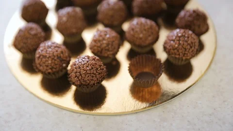 Chef cooking chocolate balls, rolling pops in sprinkles with flakes Stock Footage 102368802