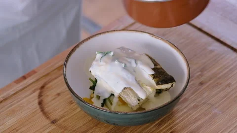 Chef cooking cod fish in creamy sauce Stock Footage 150938724