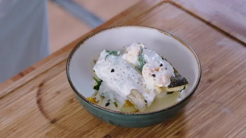Chef cooking cod fish in creamy sauce Stock Footage 150938901