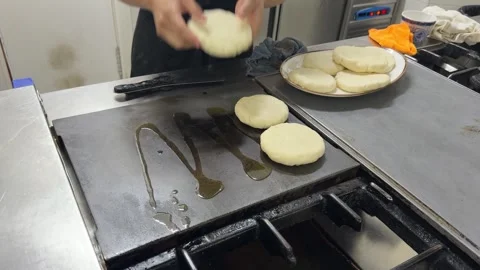 Chef cooking colombian arepas on a griddle Stock-Footage 344100054