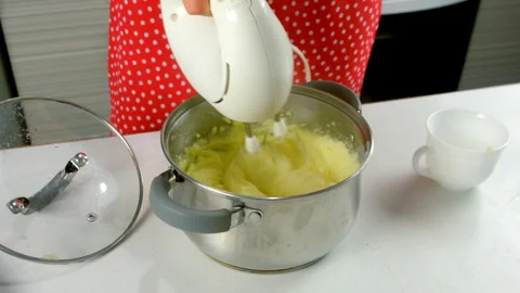 Chef cooking creamy mashed potatoes in saucepan using electric mixer on kitchen. Stock-Footage 312402988