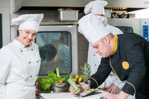 Chef Cooking, Cutting and preparing next plate Stock Photos