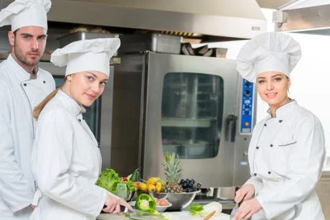 Chef Cooking, Cutting and preparing next plate Stock Photos