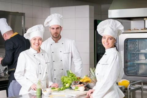 Chef Cooking, Cutting and preparing next plate Stock Photos