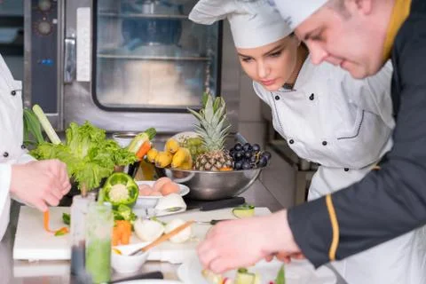 Chef Cooking, Cutting and preparing next plate Stock Photos