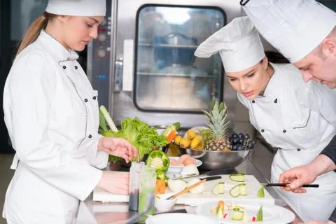 Chef Cooking, Cutting and preparing next plate Stock Photos