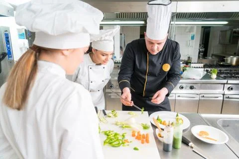Chef Cooking, Cutting and preparing next plate Stock Photos