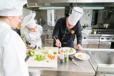 Chef Cooking, Cutting and preparing next plate Stock Photos