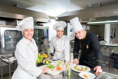 Chef Cooking, Cutting and preparing next plate Stock Photos