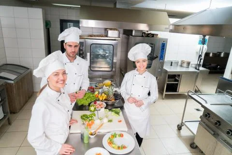 Chef Cooking, Cutting and preparing next plate Stock Photos