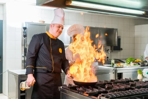 Chef Cooking, Cutting and preparing next plate Stock Photos
