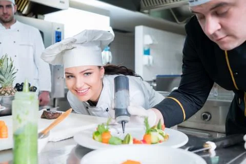 Chef Cooking, Cutting and preparing next plate Stock Photos