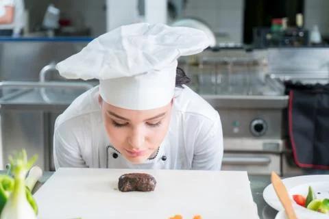 Chef Cooking, Cutting and preparing next plate Stock Photos