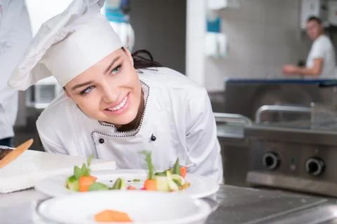 Chef Cooking, Cutting and preparing next plate Stock Photos