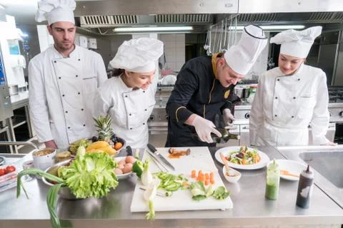 Chef Cooking, Cutting and preparing next plate Stock Photos