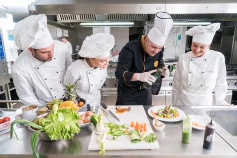 Chef Cooking, Cutting and preparing next plate Stock Photos