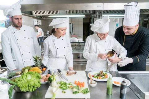 Chef Cooking, Cutting and preparing next plate Stock Photos