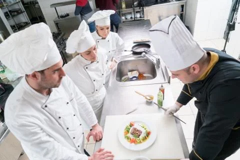 Chef Cooking, Cutting and preparing next plate Stock Photos