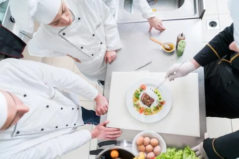 Chef Cooking, Cutting and preparing next plate Stock Photos