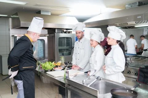 Chef Cooking, Cutting and preparing next plate Stock Photos