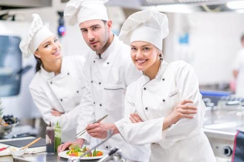 Chef Cooking, Cutting and preparing next plate Stock Photos