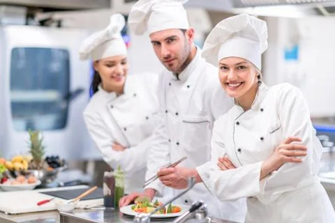 Chef Cooking, Cutting and preparing next plate Stock Photos