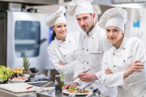 Chef Cooking, Cutting and preparing next plate Stock Photos