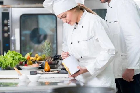 Chef Cooking, Cutting and preparing next plate Stock Photos