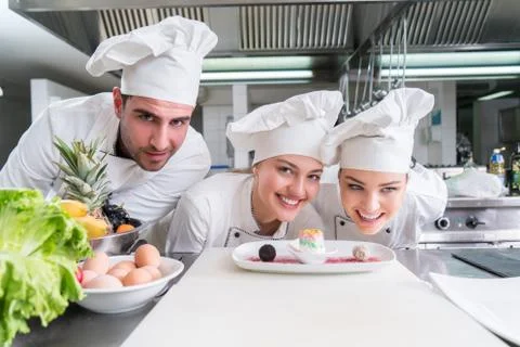 Chef Cooking, Cutting and preparing next plate Stock Photos