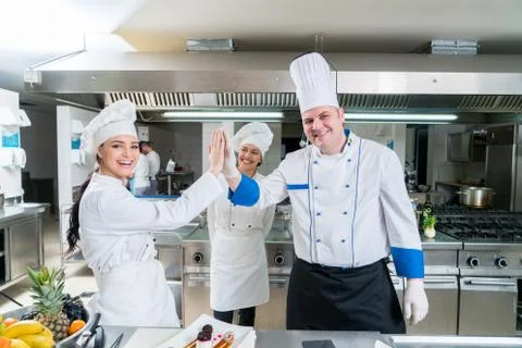 Chef Cooking, Cutting and preparing next plate Stock Photos