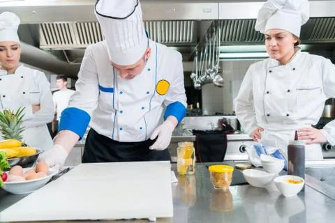 Chef Cooking, Cutting and preparing next plate Stock Photos