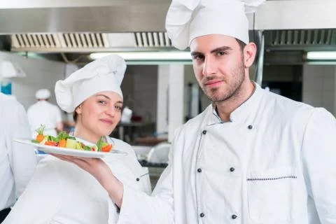 Chef Cooking, Cutting and preparing next plate Stock Photos
