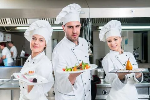 Chef Cooking, Cutting and preparing next plate Stock Photos